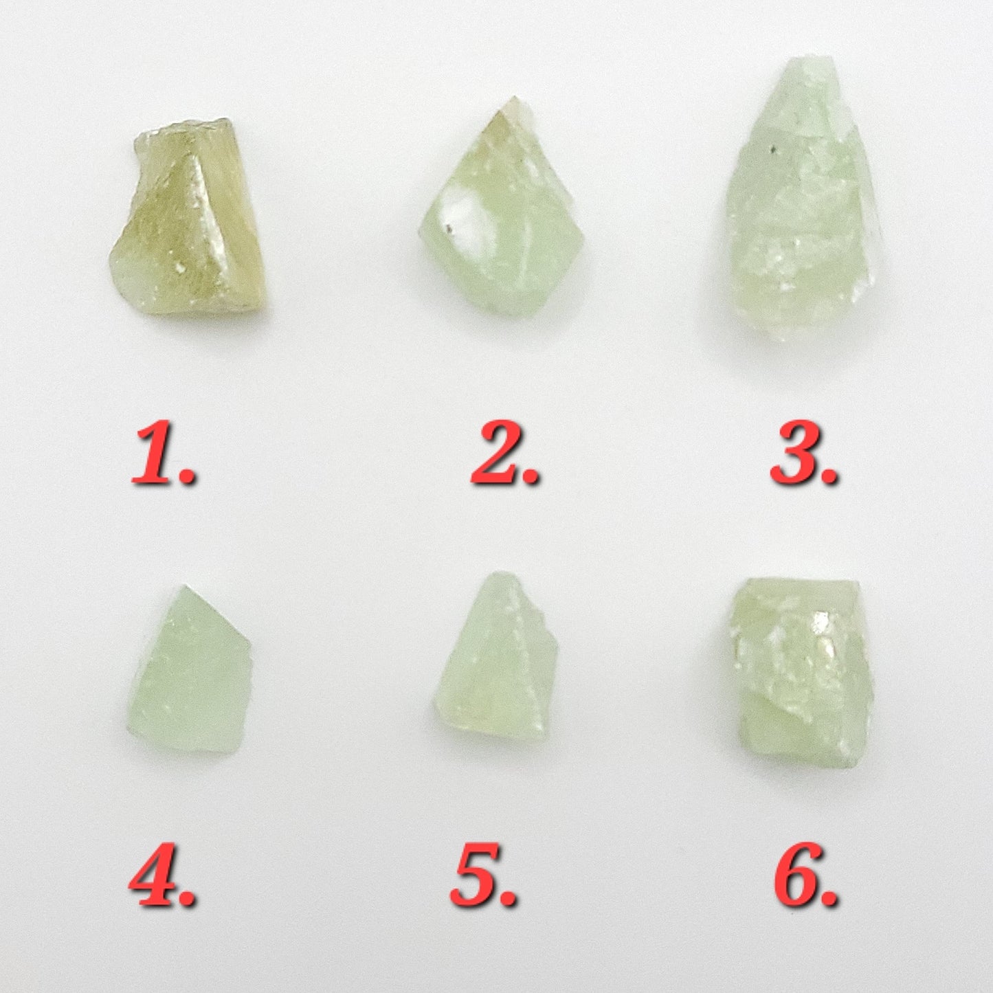 Raw green calcite crystals in varying shapes and sizes, showcasing their natural beauty and unique textures.