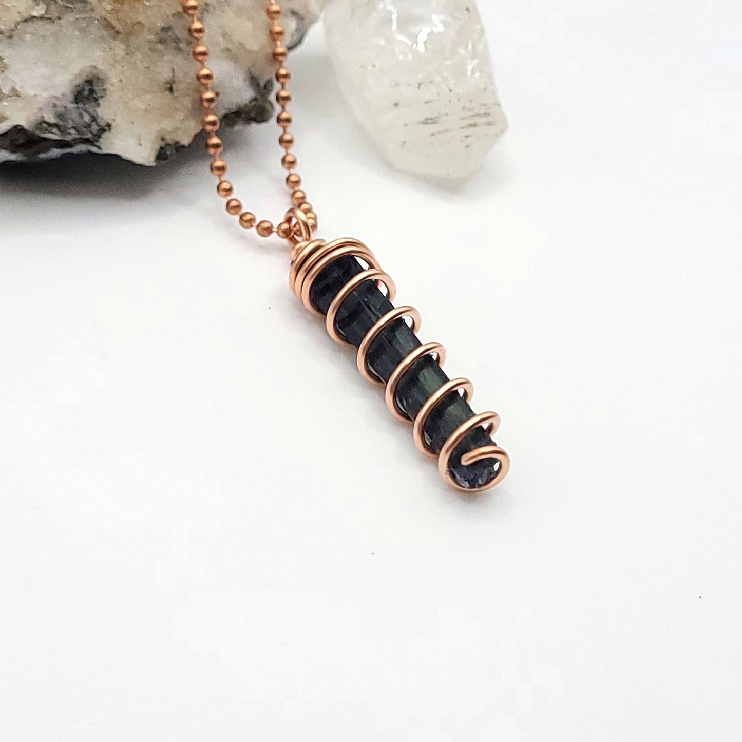 side view on white background of vivianite pendant in copper