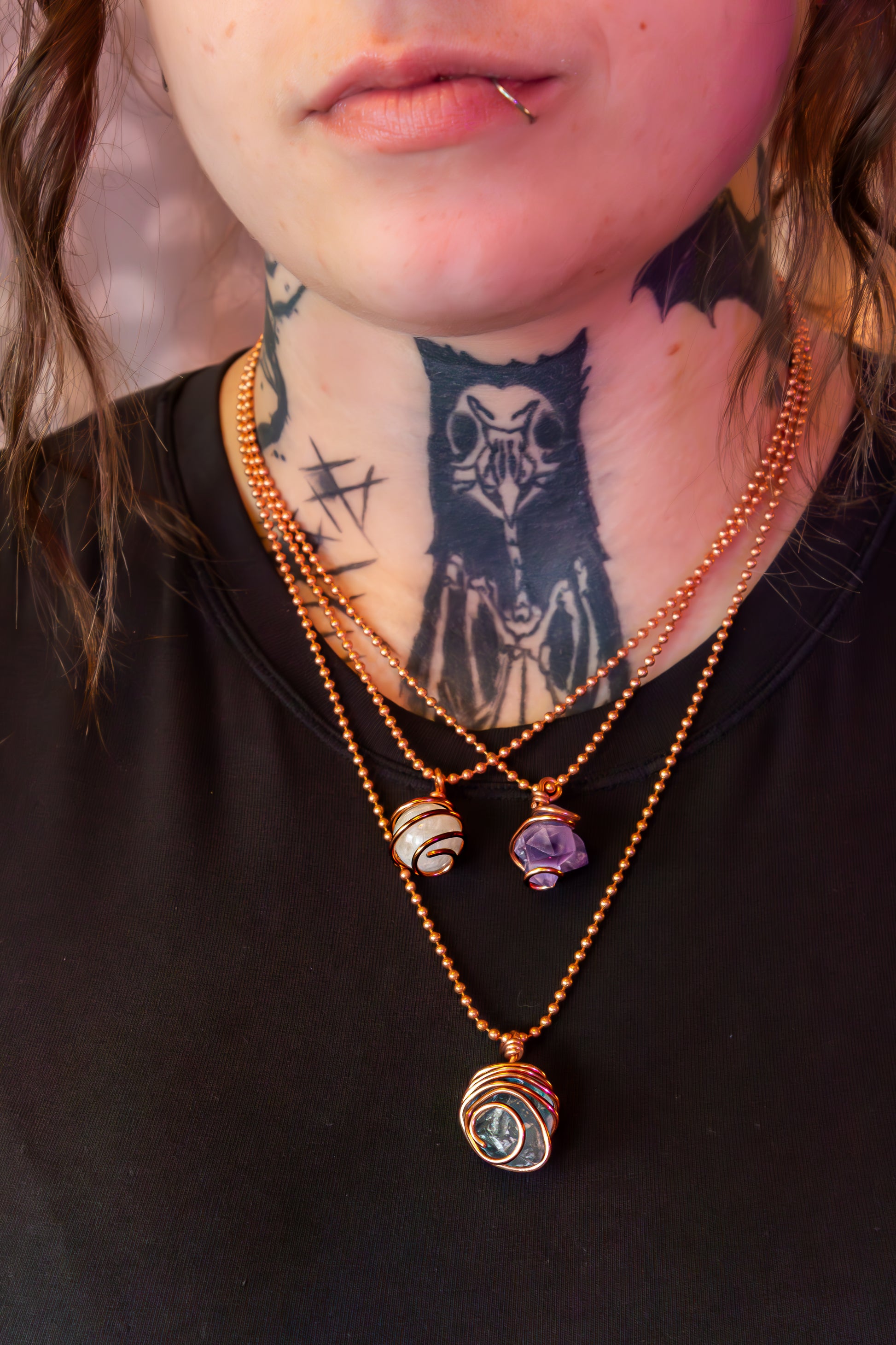 raw amethyst in copper on models neck