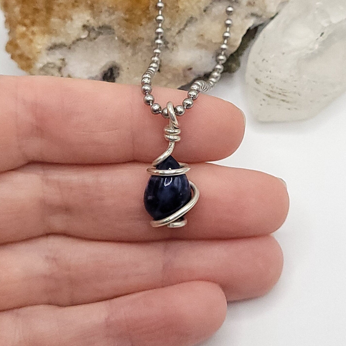 Sodalite Crystal Teardrop Necklace in Silver Wire in hand