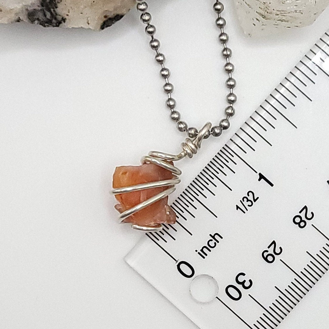Raw Carnelian Crystal Necklace in Silver Wire next to ruler , about 1 inch
