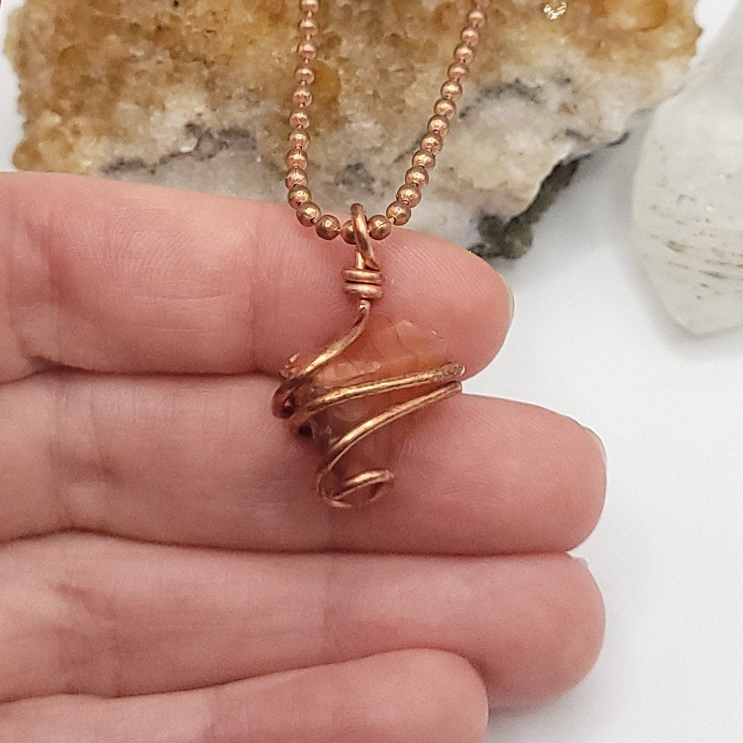 Raw Carnelian Crystal Necklace in Copper in hand