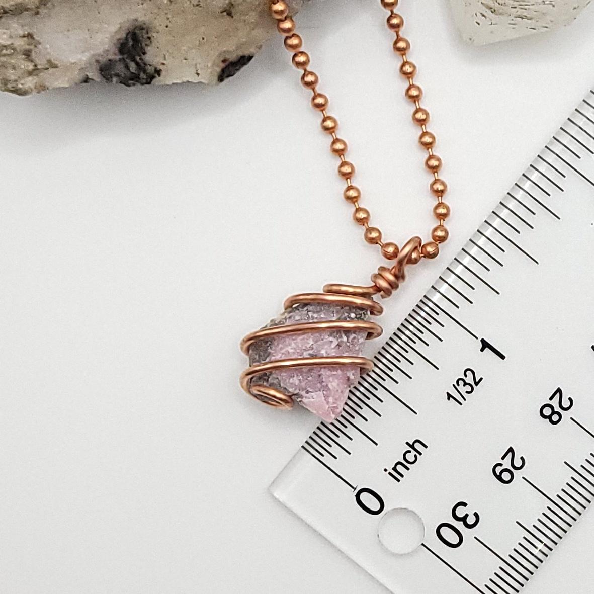 Raw Pink Moonstone Necklace in Copper next to ruler , just over 1 inch