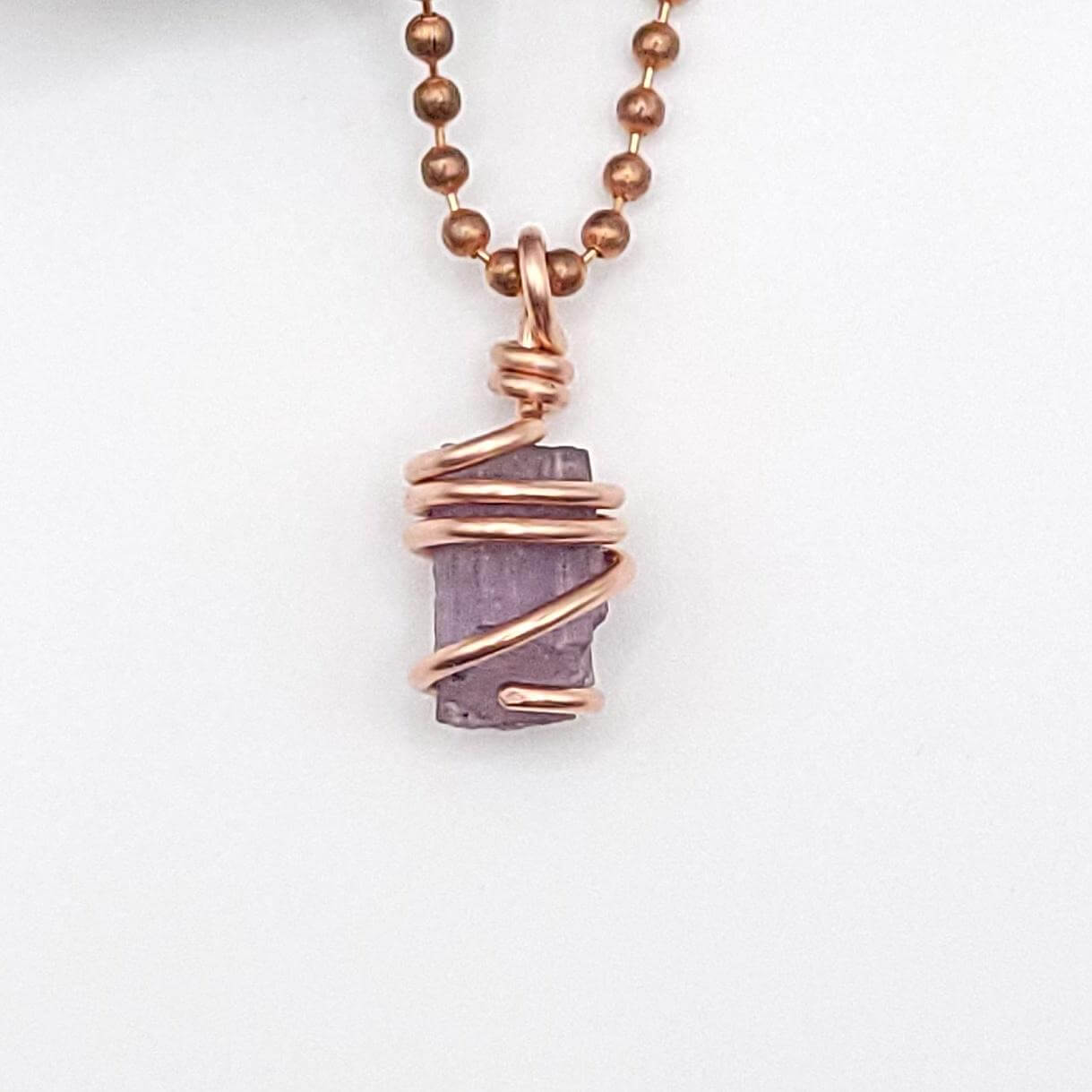 Raw Purple Scapolite Crystal Pendant in Copper, close up