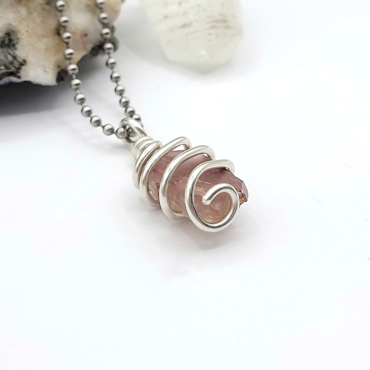 lithium quartz necklace in sterling silver wire on white background side view