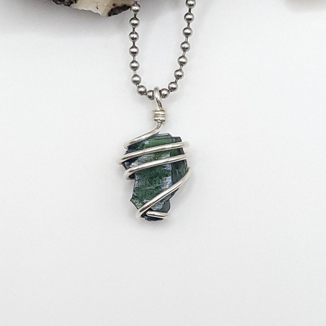 vivianite in sterling silver wire on a white background