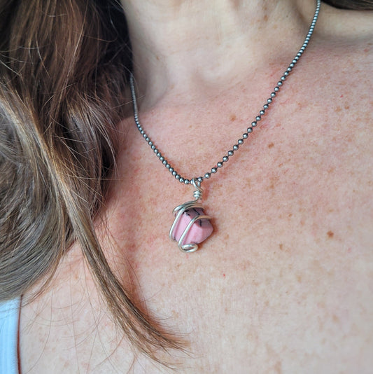 model wearing rhodonite necklace in silver