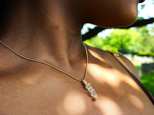 model wearing a lemurian quartz necklace in gold wire