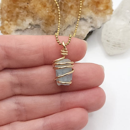 Raw Aquamarine Crystal Necklace in Gold, in hand