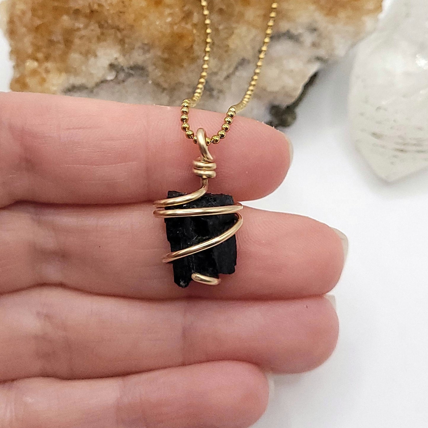 Raw Black Tourmaline Crystal Necklace in Gold Wire in hand