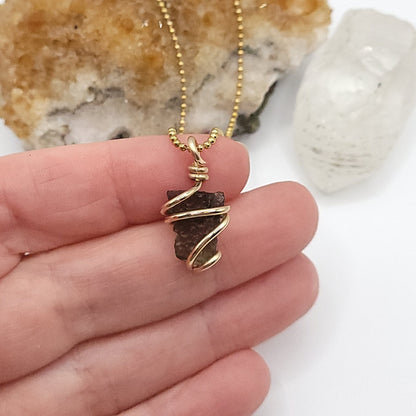 Raw Moldavite Crystal Necklace in gold in hand