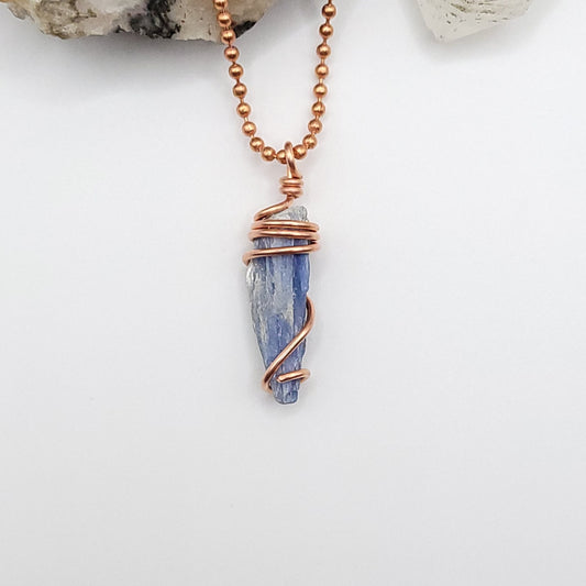 raw blue kyanite necklace in copper on white background