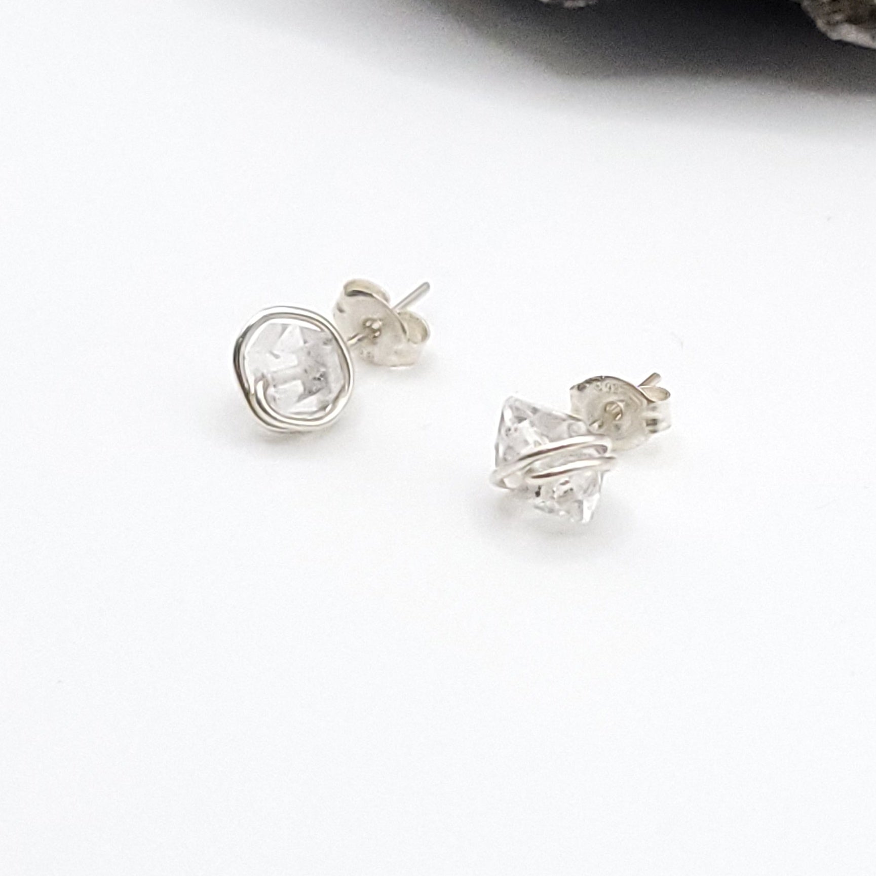 Silver stud earrings with herkimer diamonds on a white background