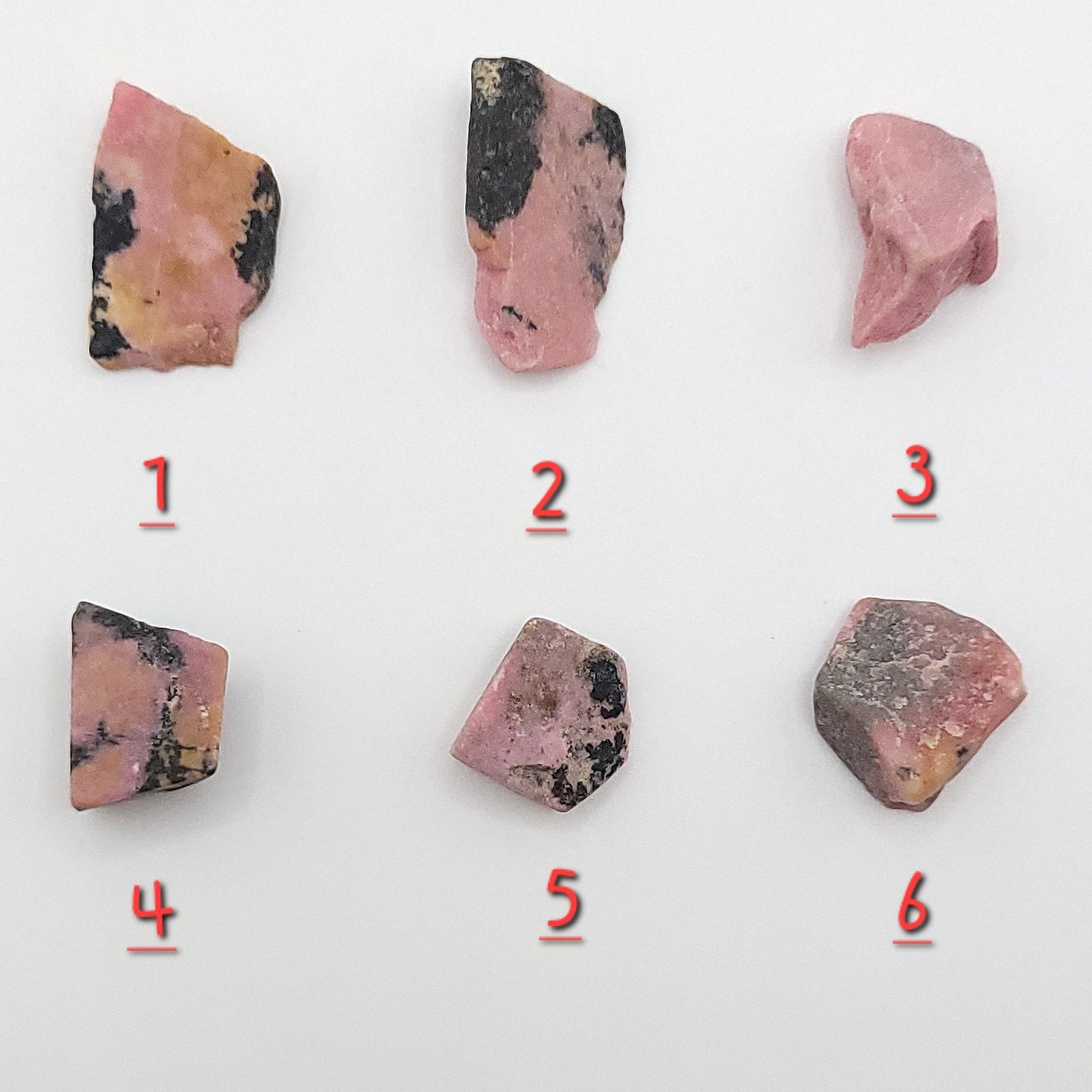 choice of 6 rhodonite pieces to choose from on white background