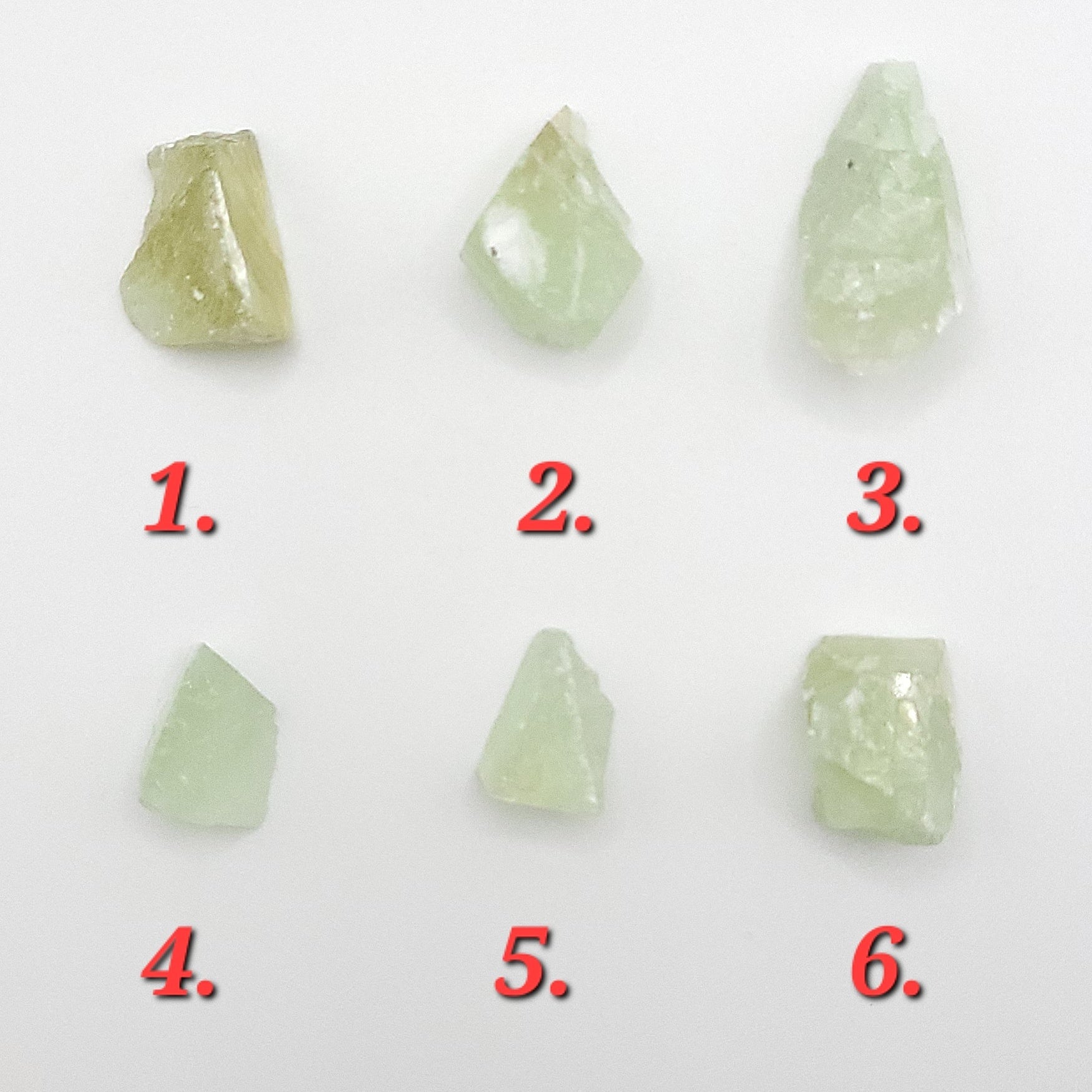 Raw green calcite crystals in varying shapes and sizes, showcasing their natural beauty and unique textures.