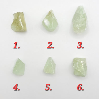 Raw green calcite crystals in varying shapes and sizes, showcasing their natural beauty and unique textures.