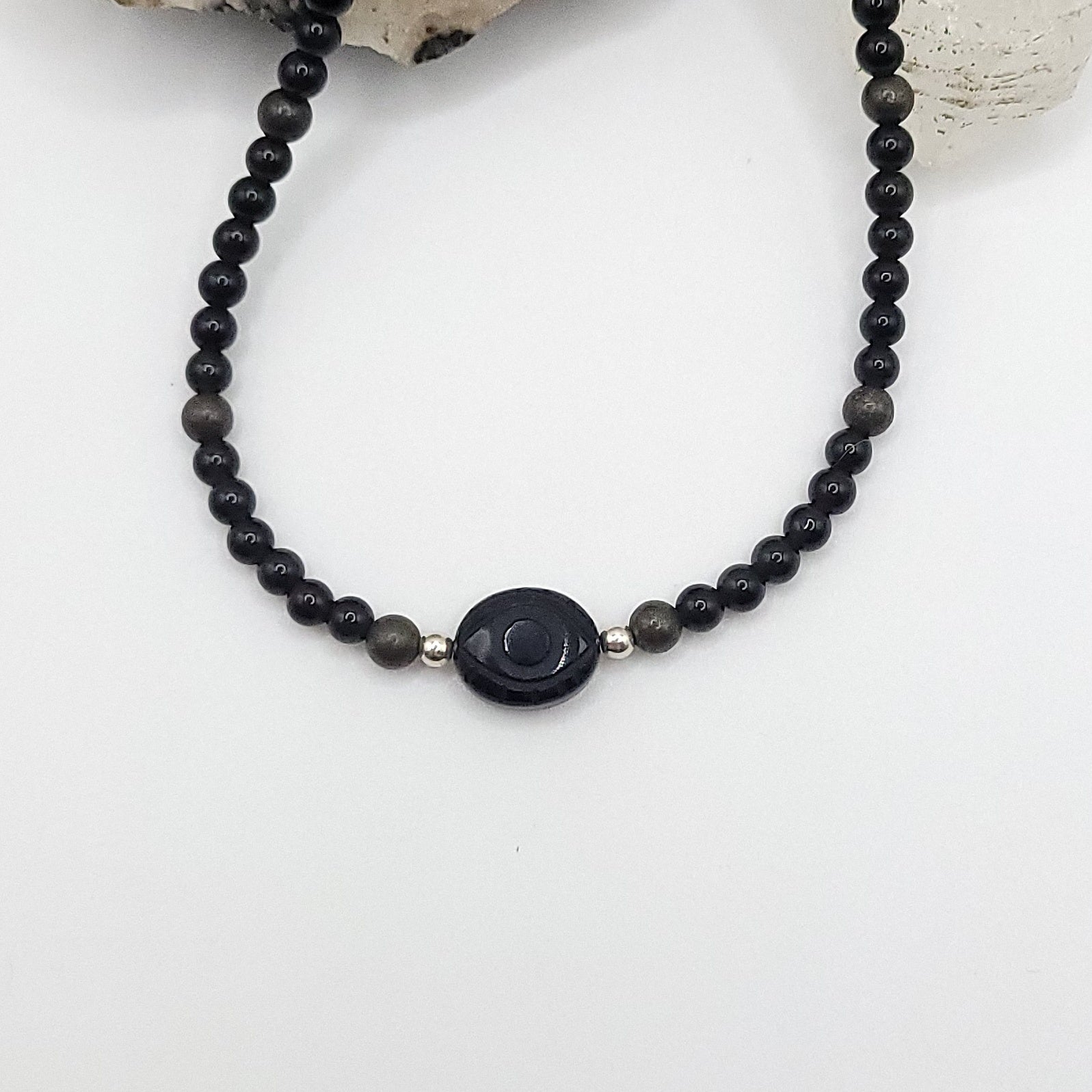 Onyx Evil Eye Necklace featuring Obsidian and Pyrite beads for protection and grounding energy.