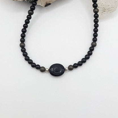 Onyx Evil Eye Necklace featuring Obsidian and Pyrite beads for protection and grounding energy.
