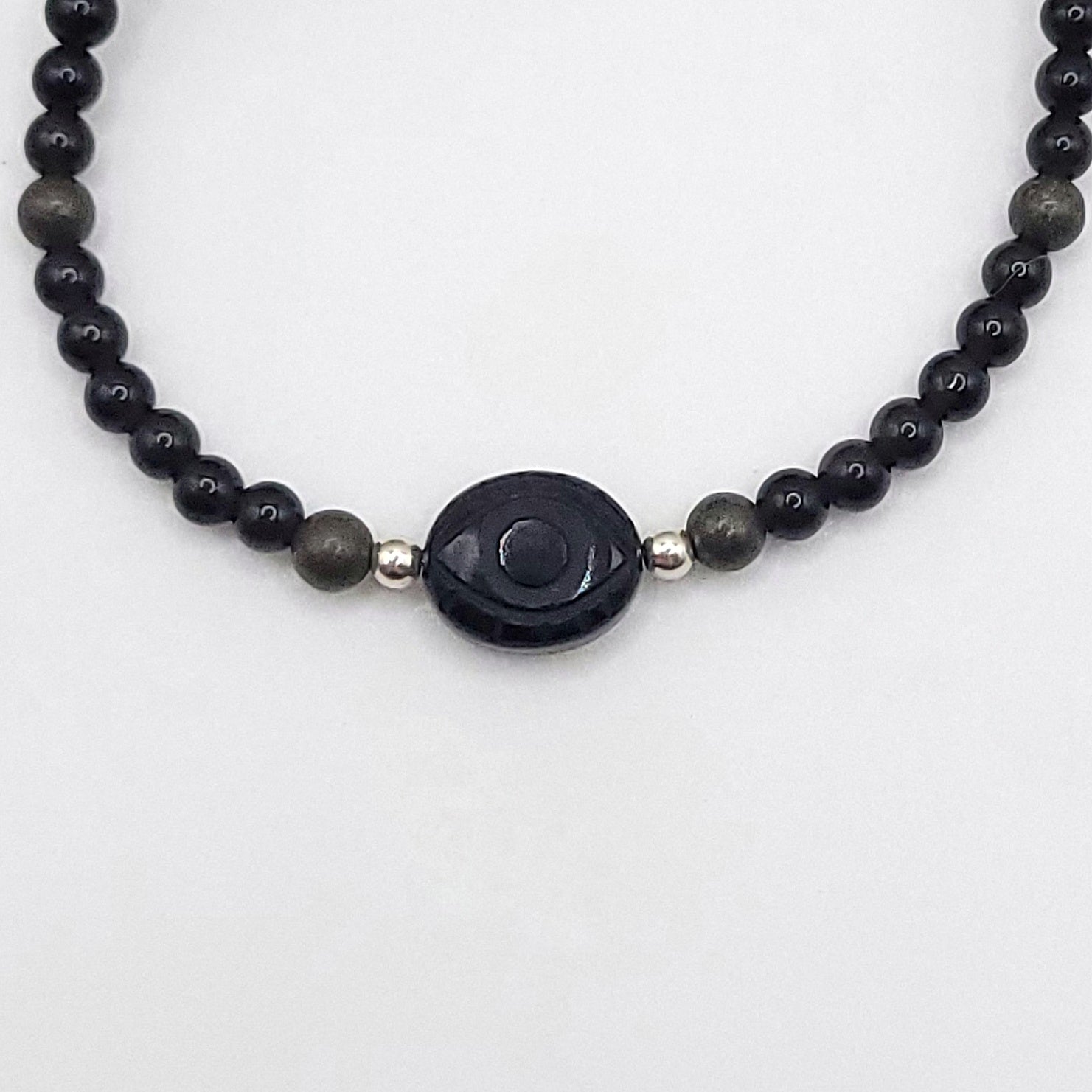 Onyx Evil Eye Necklace - Crystal for Grounded Protection featuring Obsidian and Pyrite beads.