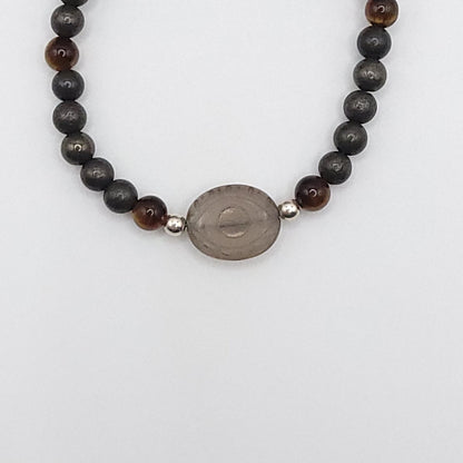 Smoky Quartz Evil Eye necklace featuring Pyrite and Tiger’s Eye beads for grounded confidence and empowerment.