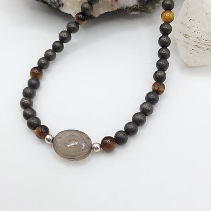 Smoky Quartz Evil Eye Necklace featuring Pyrite and Tiger’s Eye beads for grounded confidence and empowerment.