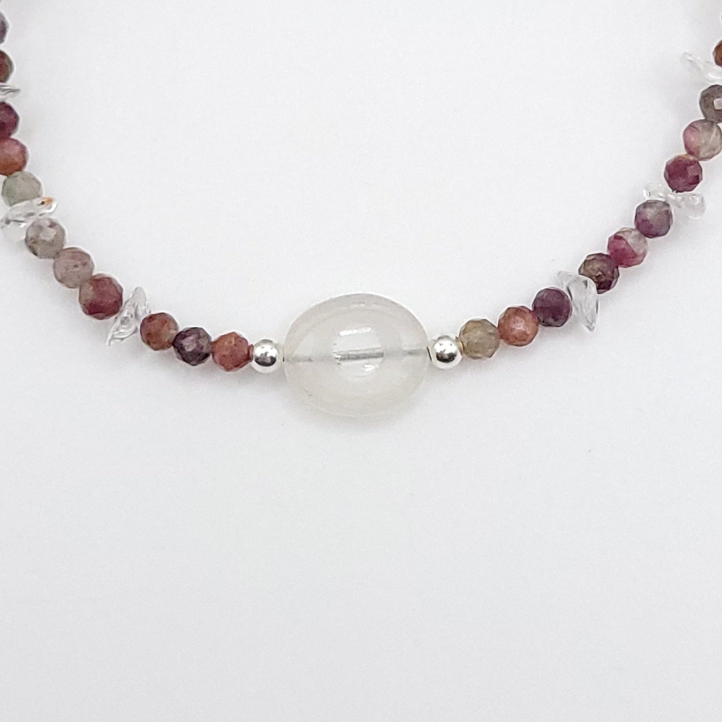 Close-up of a Clear Quartz Evil Eye Necklace featuring Multi-Color Tourmaline and sterling silver accents.