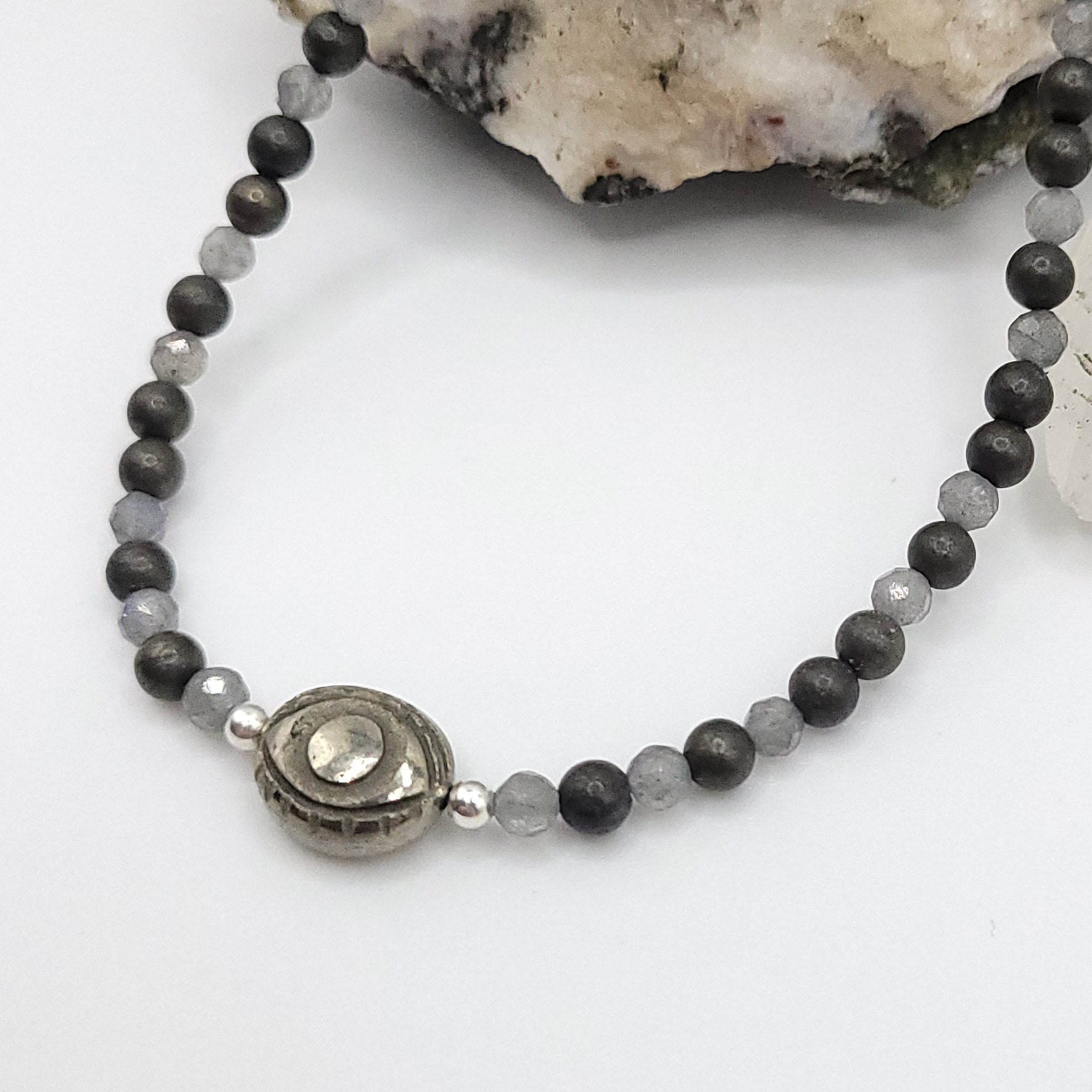pyrite evil eye necklace on white background
