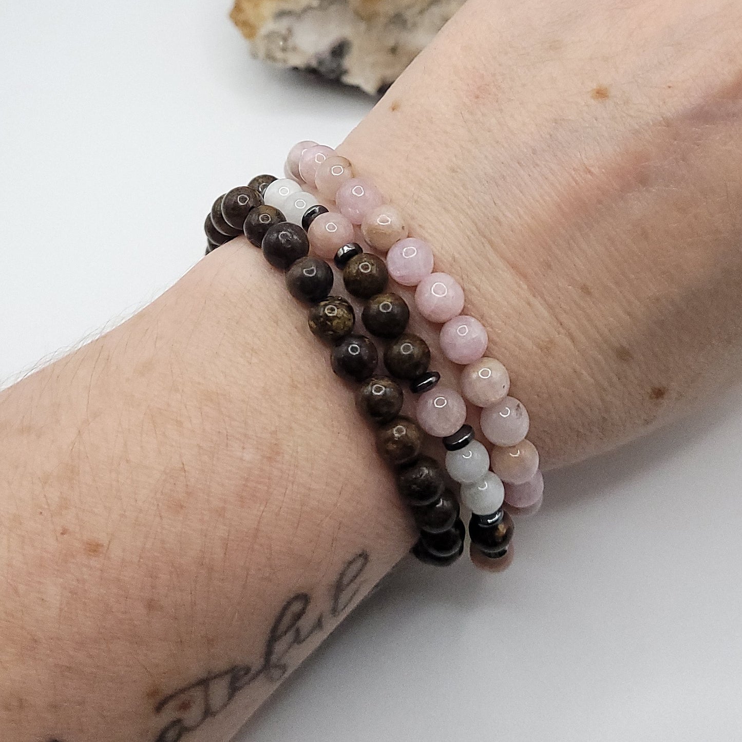 kunzite, bronzite, moonstone 3 bracelet stack on wrist