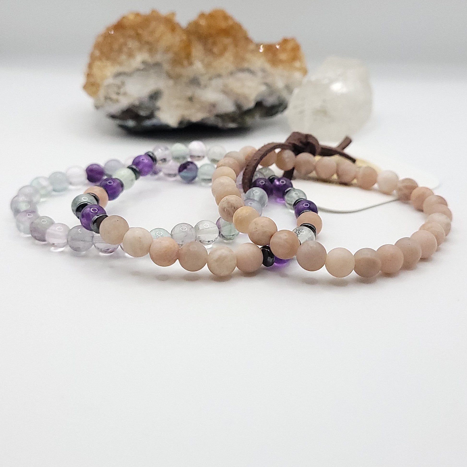 stack of 3 stretch bracelets made with fluorite, peach moonstone, amethyst