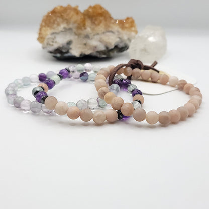 stack of 3 stretch bracelets made with fluorite, peach moonstone, amethyst