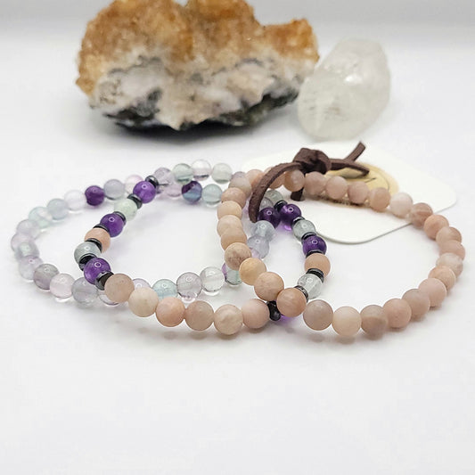 stack of 3 stretch bracelets made with fluorite, peach moonstone, amethyst