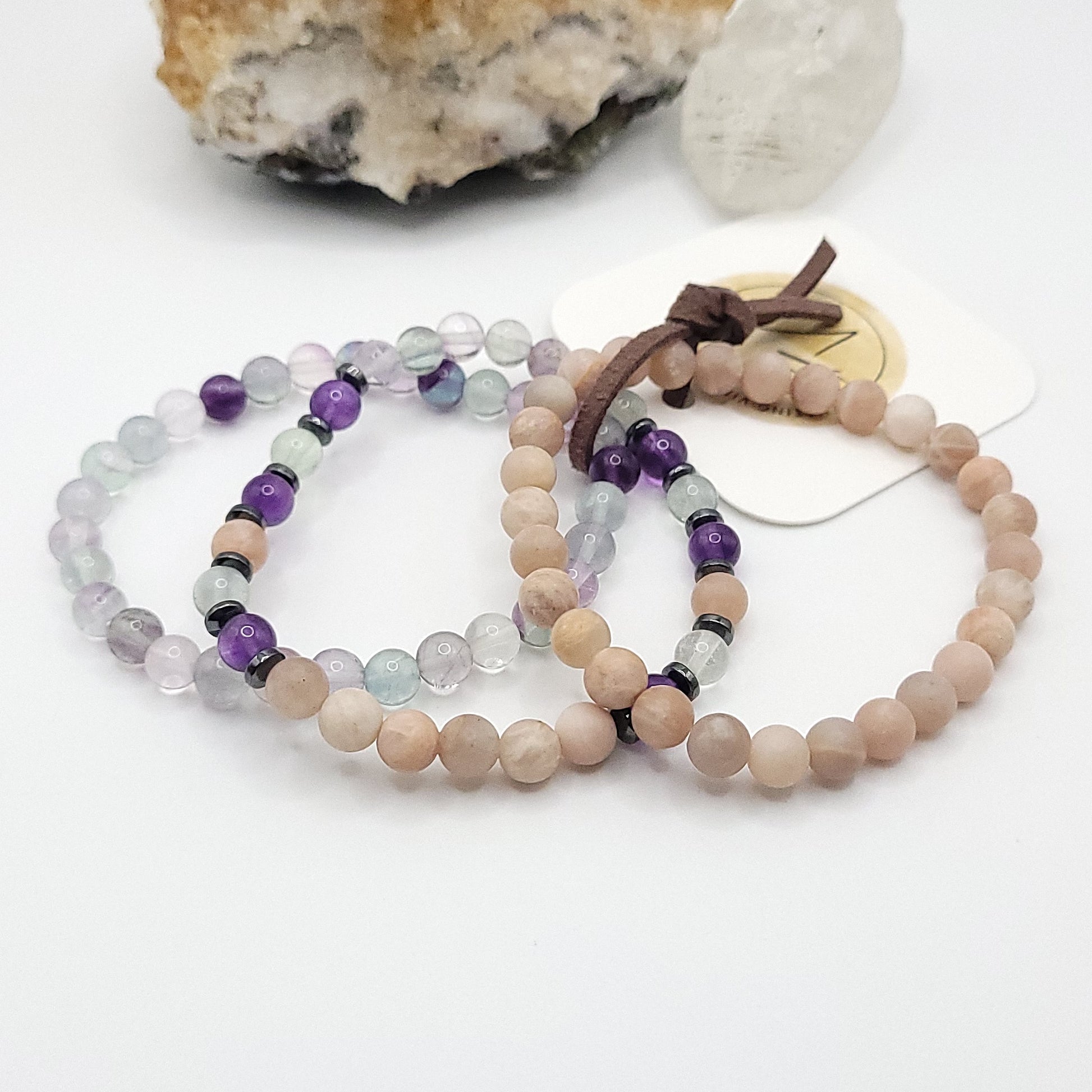 stack of 3 stretch bracelets made with fluorite, peach moonstone, amethyst