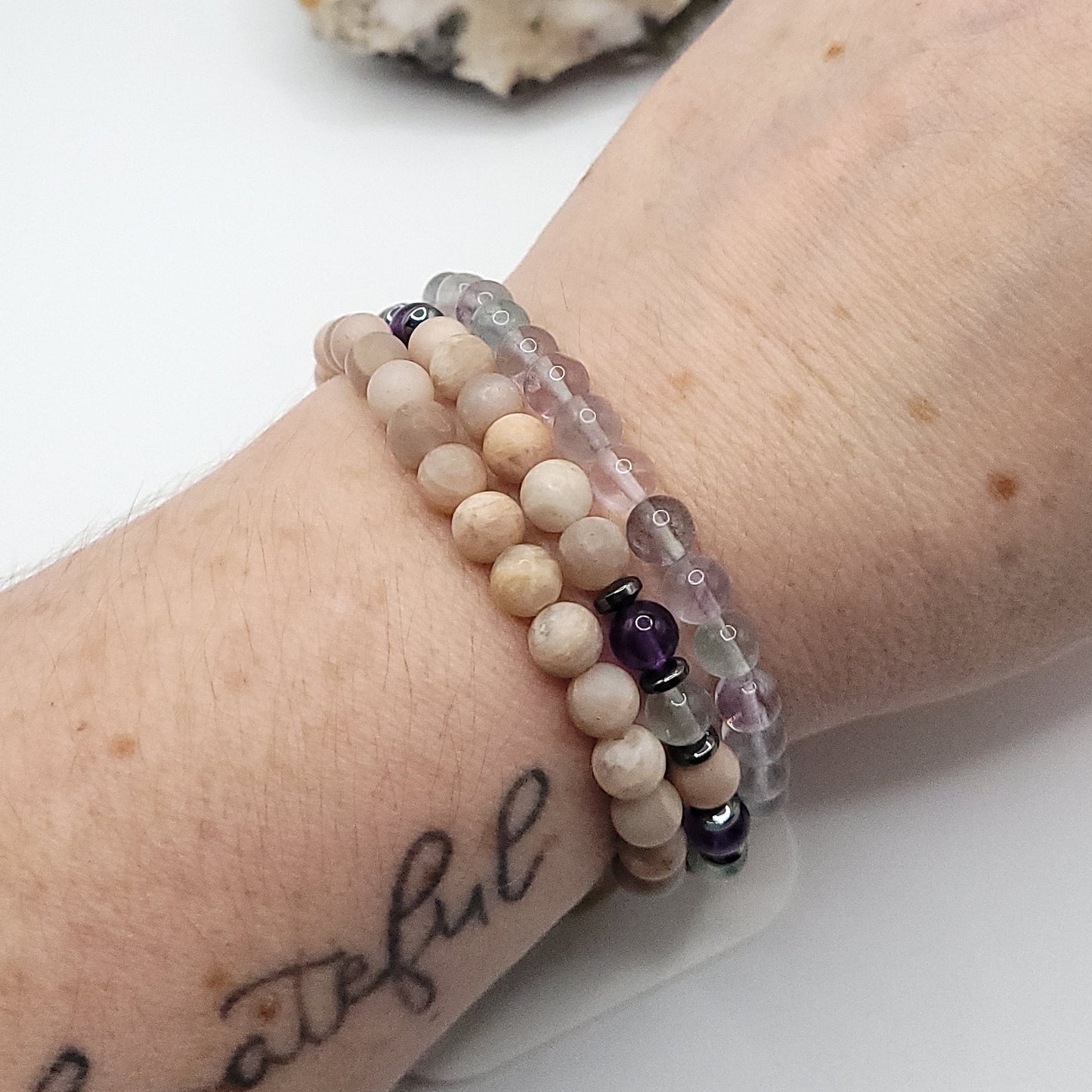 stack of 3 stretch bracelets made with fluorite, peach moonstone, amethyst