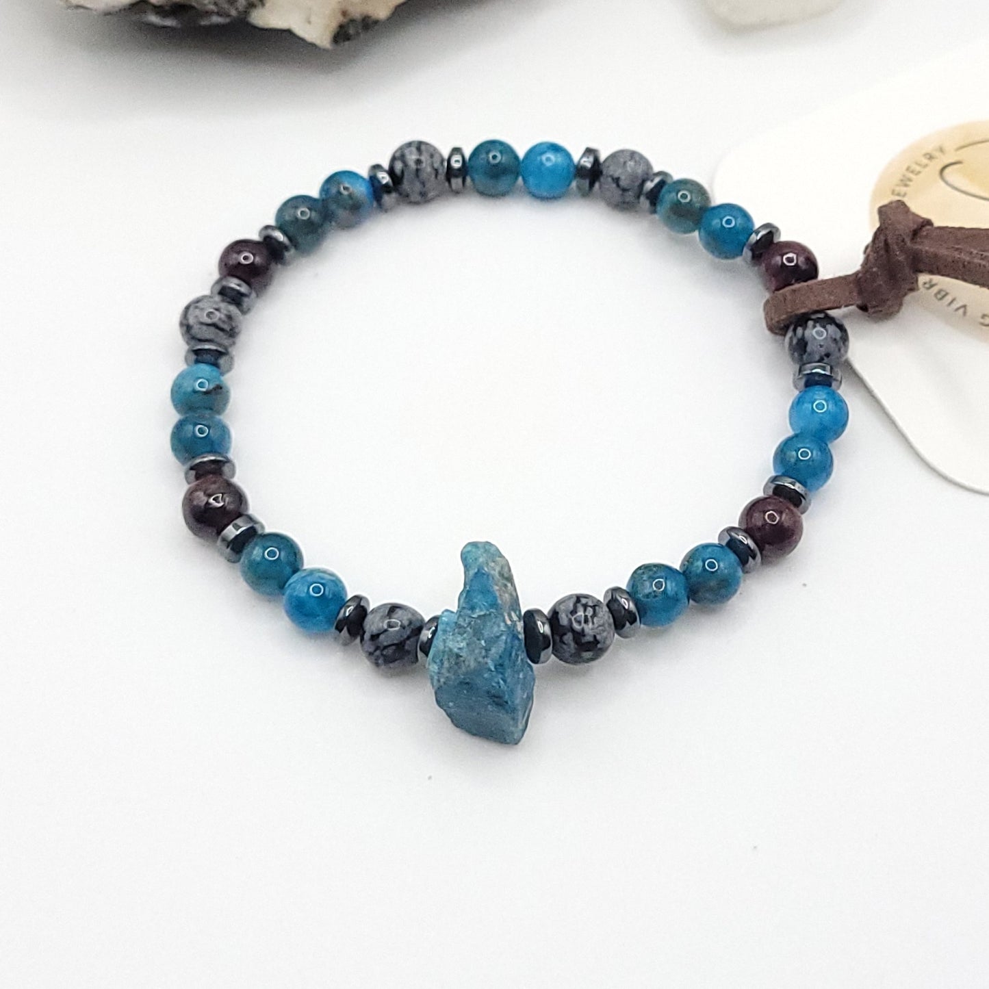 Blue Apatite Garnet & Snowflake Obsidian bracelet on white background