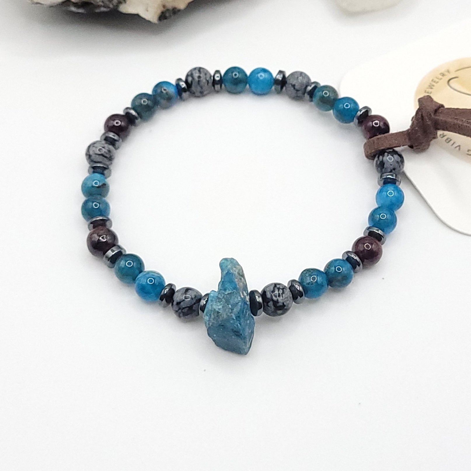 Blue Apatite Garnet & Snowflake Obsidian bracelet on white background