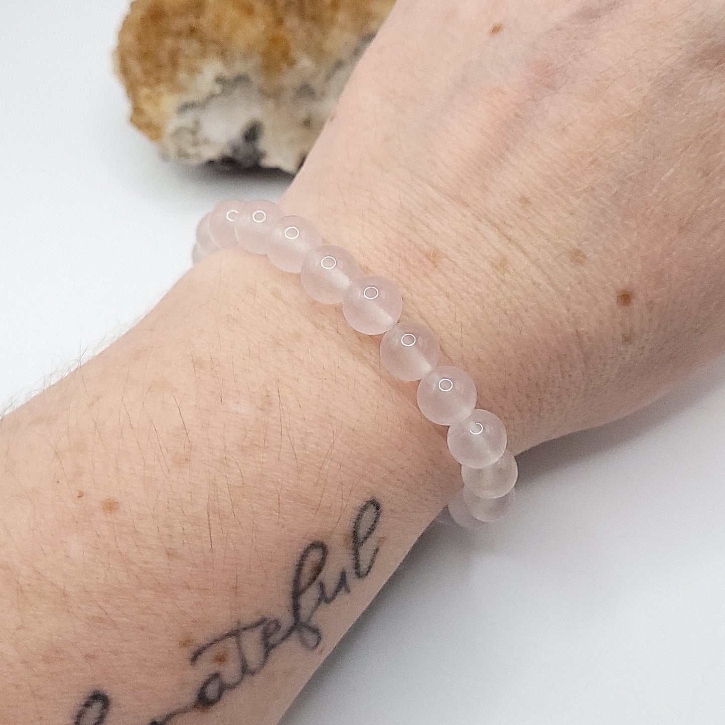 rose quartz bracelet on wrist