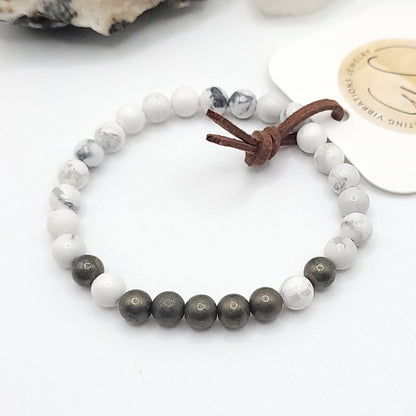 pyrite & howlite bracelet , 7" beaded stretch bracelet on white background