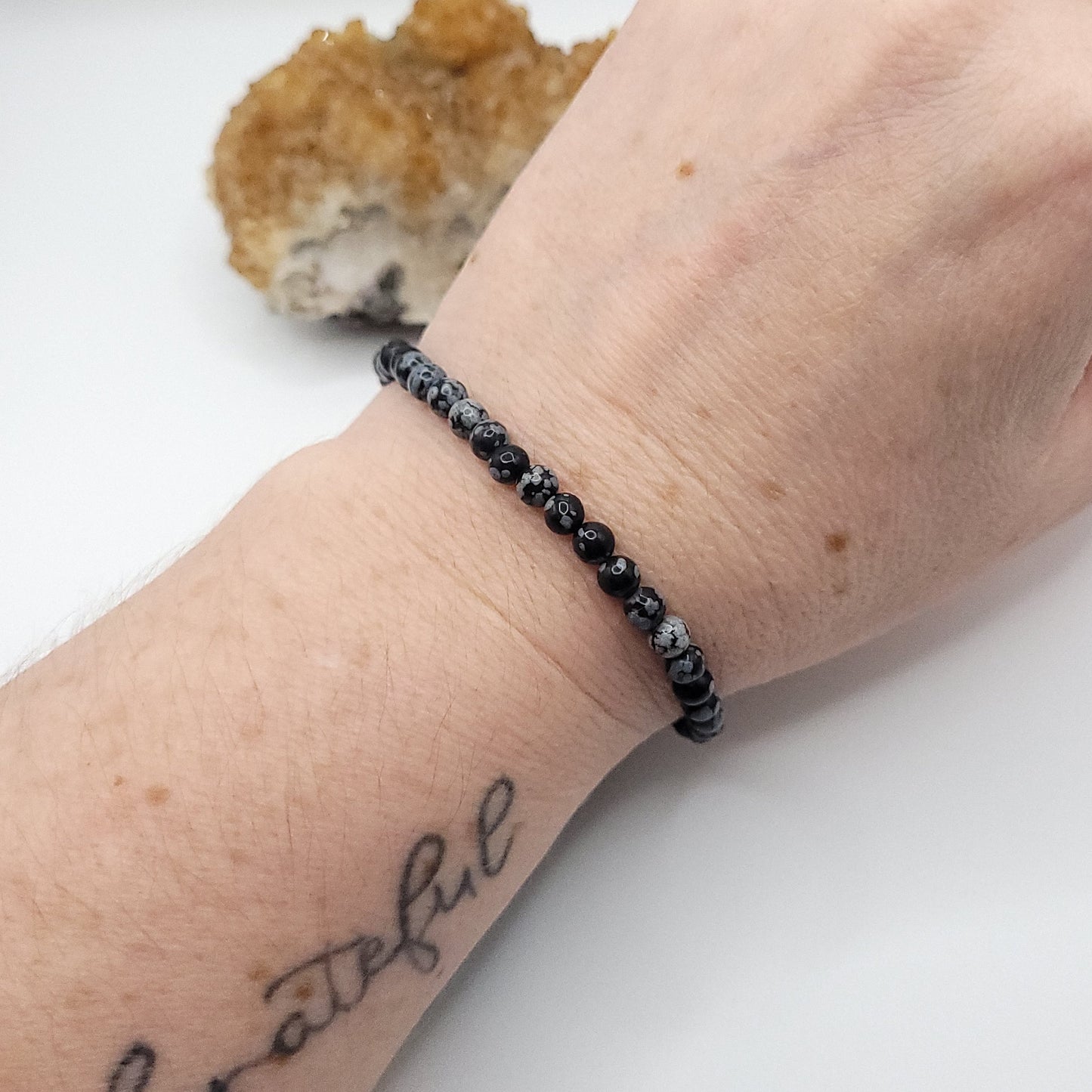snowflake obsidian stretch bracelet on wrist