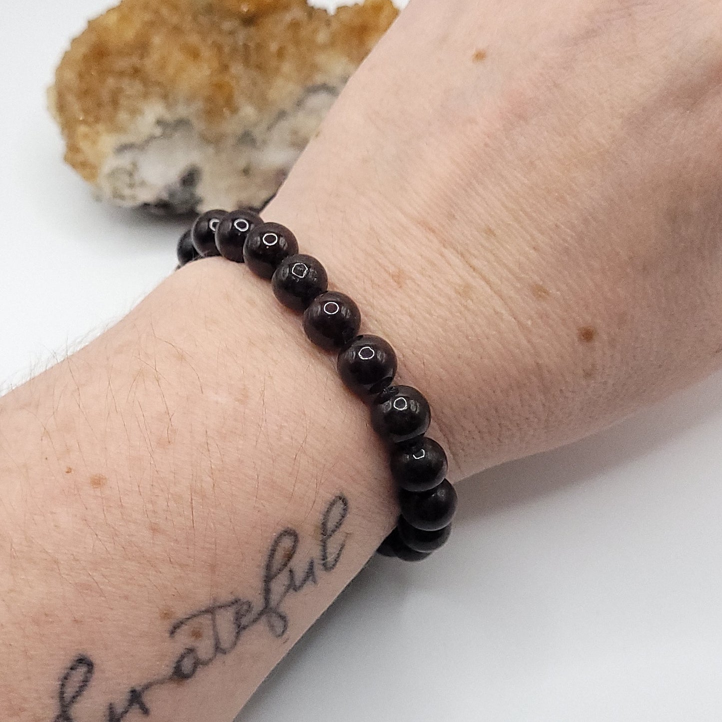 garnet stretch bracelet on wrist