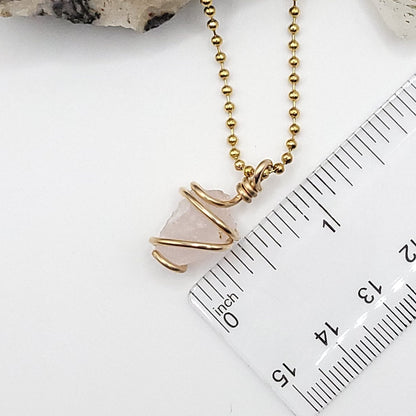 Raw Rose Quartz necklace in gold, featuring authentic raw crystal wrapped in 14k gold filled wire.
