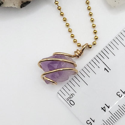 raw amethyst necklace in 14k gold filled wire next to ruler measuring just over 1 inch