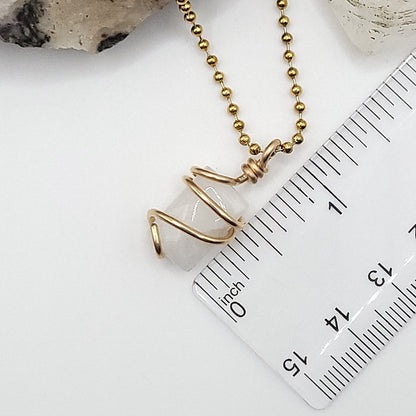 rectangular rainbow moonstone necklace in 14k gold filled next to ruler measuring about 1 inch