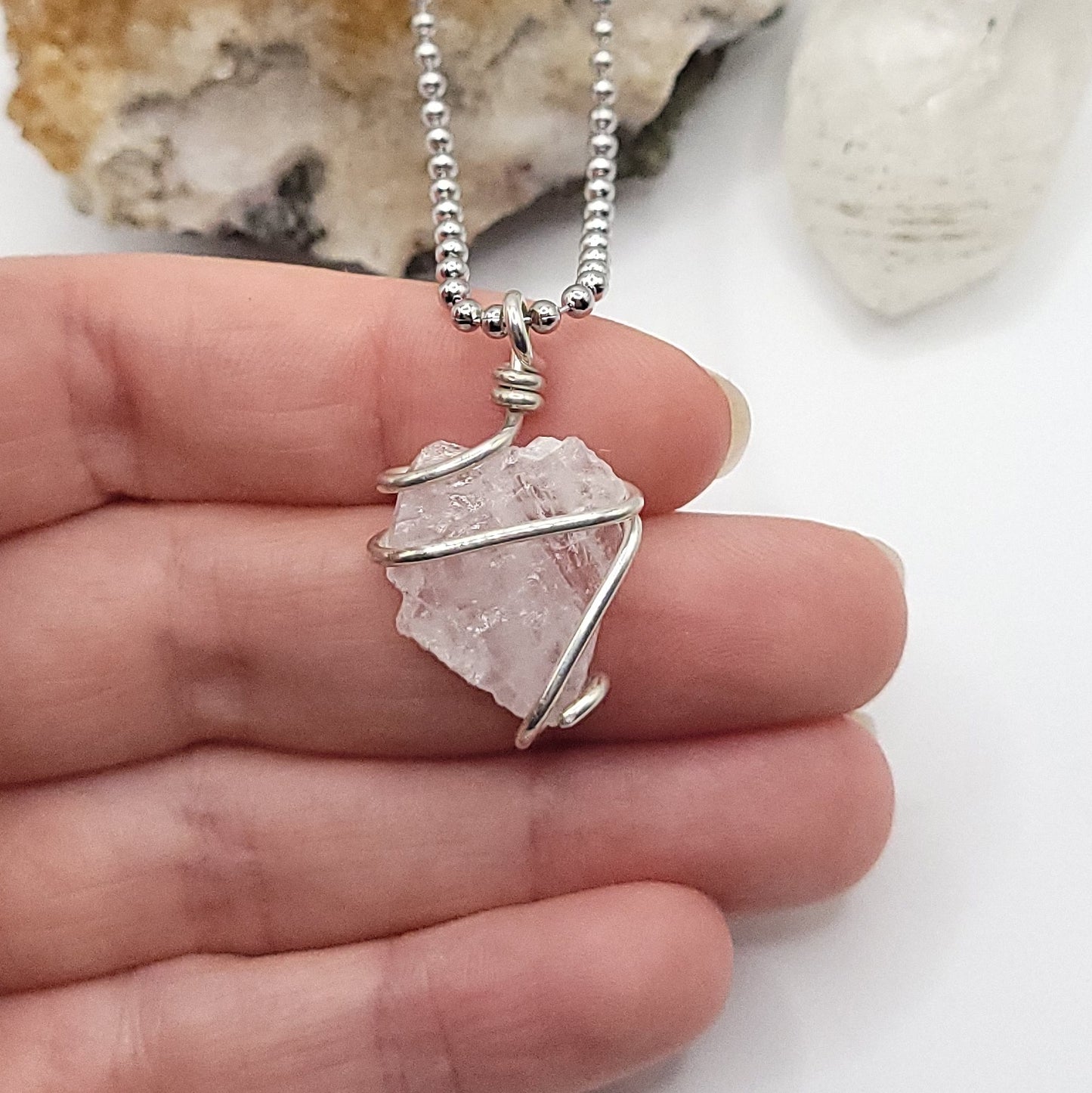 raw rose quartz necklace in sterling silver in hand