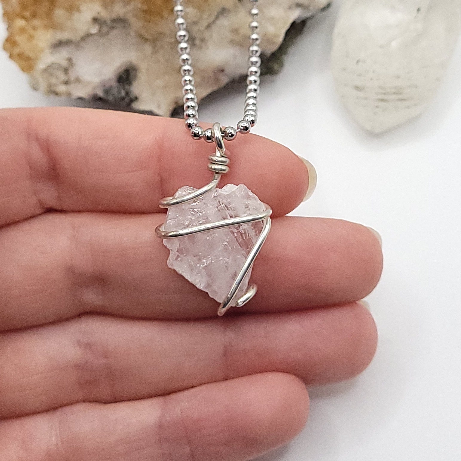 raw rose quartz necklace in sterling silver in hand