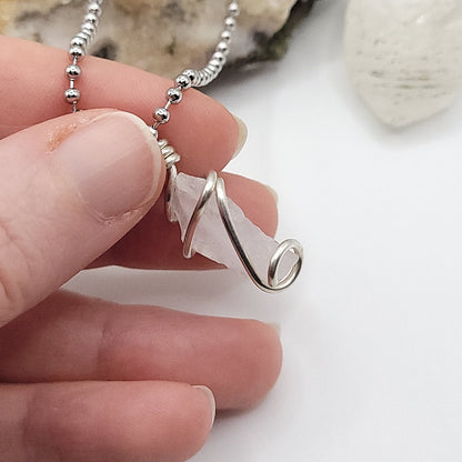 raw rose quartz necklace in sterling silver in hand side view