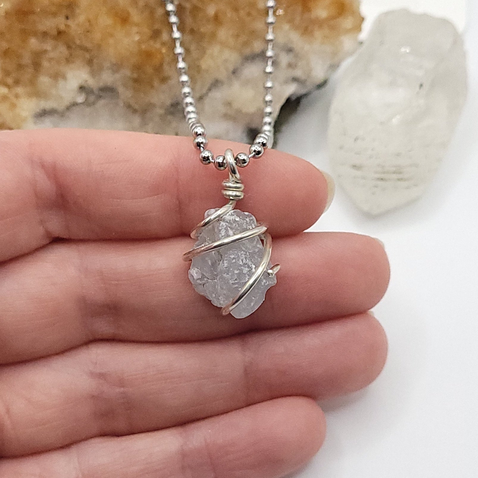 raw celestite necklace in sterling silver in hand