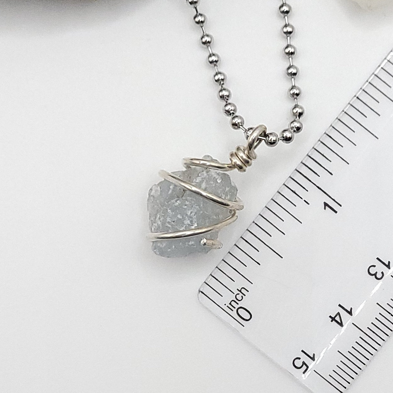 raw celestite necklace in sterling silver next to ruler measuring just over 1 inch