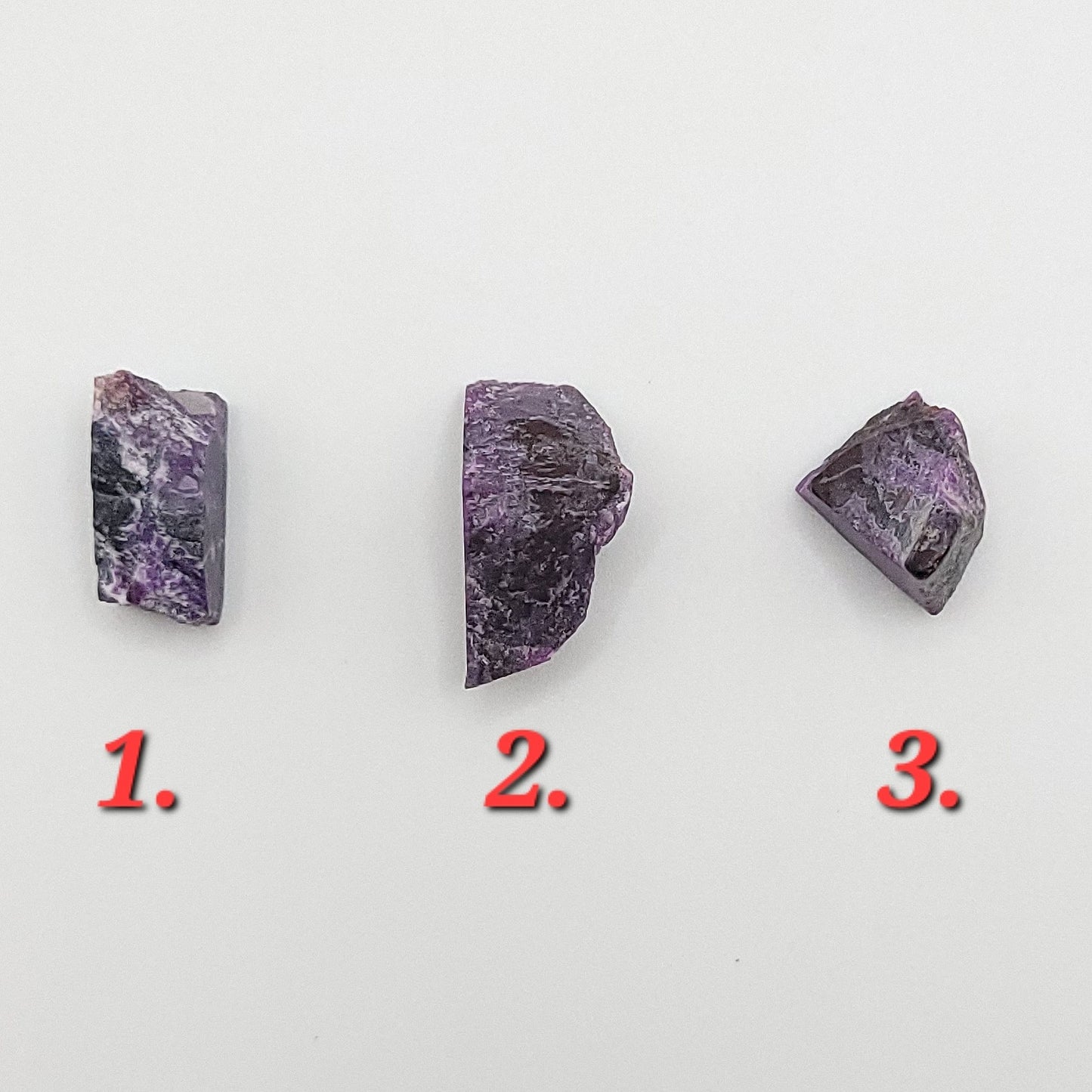 Three pieces of raw sugilite showing different sizes to choose from for raw sugilite necklace