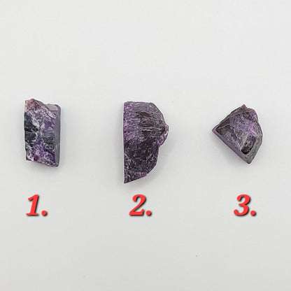 Three pieces of raw sugilite showing different sizes to choose from for raw sugilite necklace