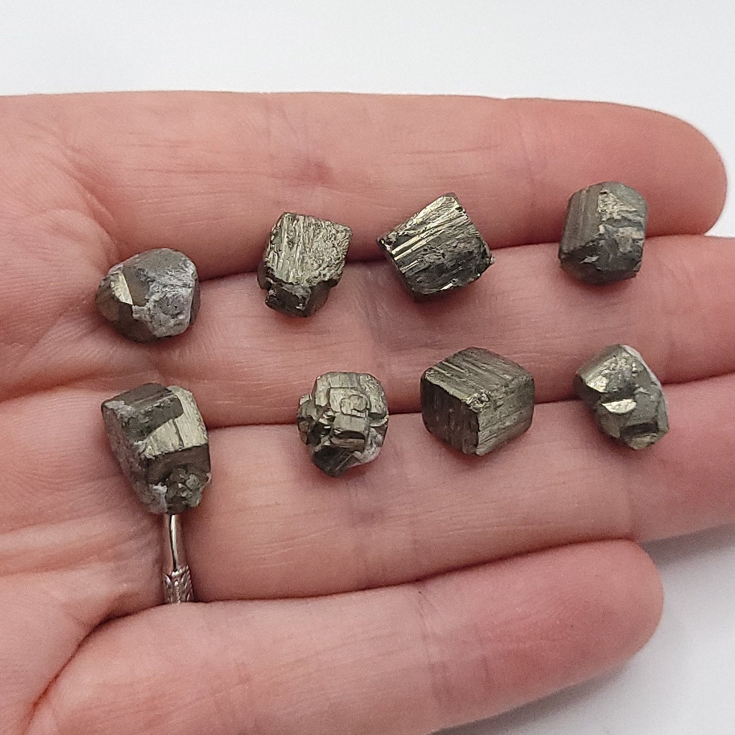 Raw pyrite crystals in a hand to choose from for raw pyrite necklace